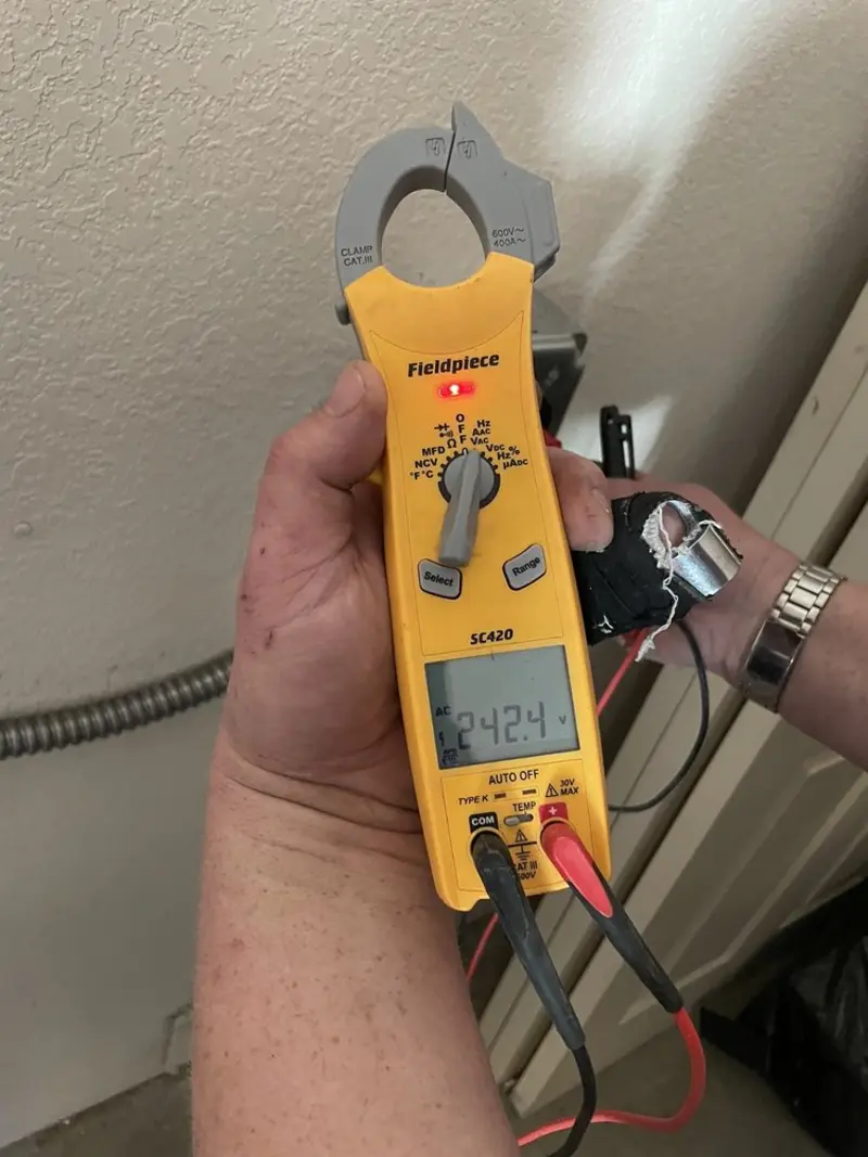 Voltage testing with clamp meter during Whole House Surge Protector in Sea Cliff